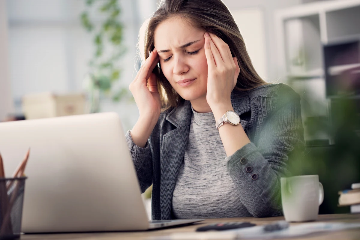 working woman experiencing headache